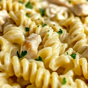 Close-up of Creamy Garlic Parmesan Chicken Pasta showing texture, layers, and glossy finish