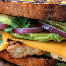 Close-up of Savory Chicken Avocado Melt showing texture, layers, and glossy finish