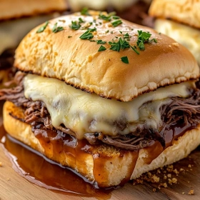Close-up of Savory French Dip Sliders showing texture, layers, and glossy finish